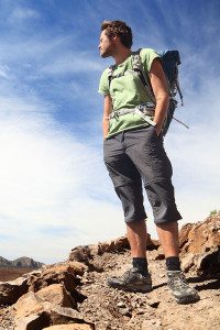 Traveling Man Standing on Desert Rocks